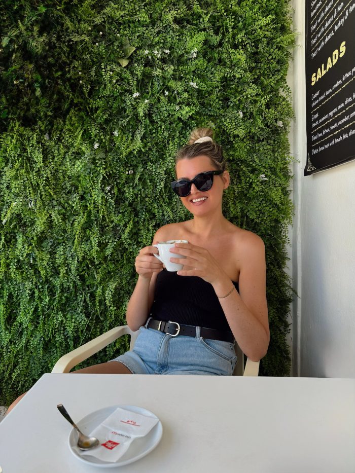 blonde girl holding drink and smiling