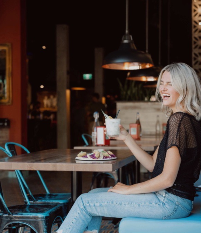 girl sipping drink in bar