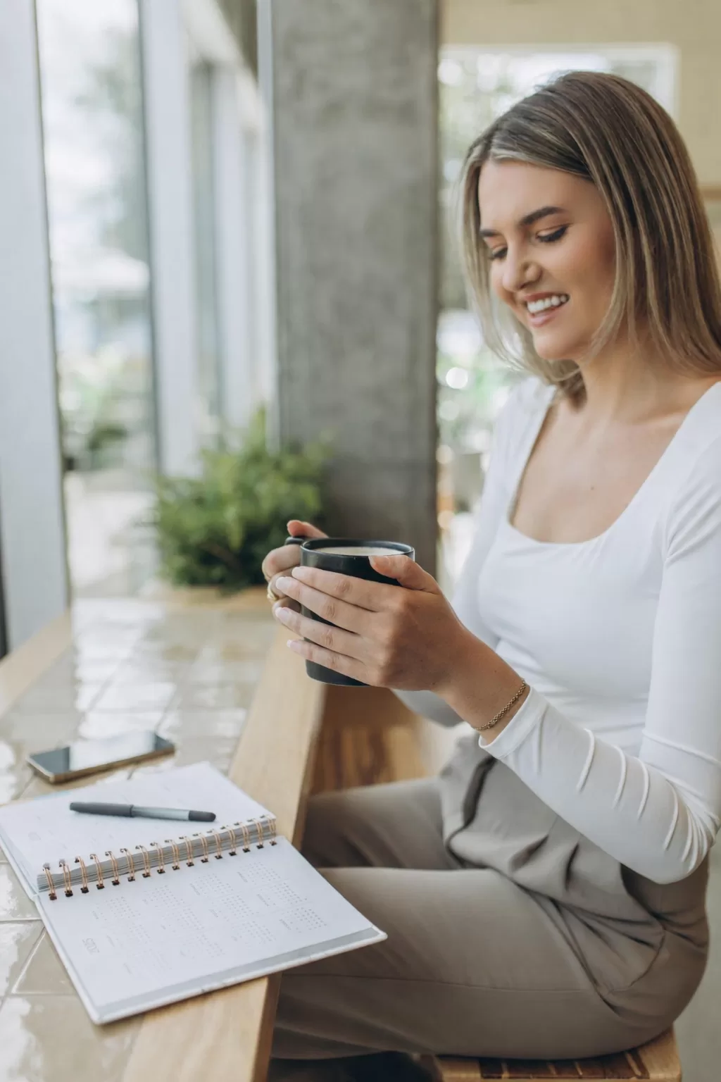 blonde girl holding a latte